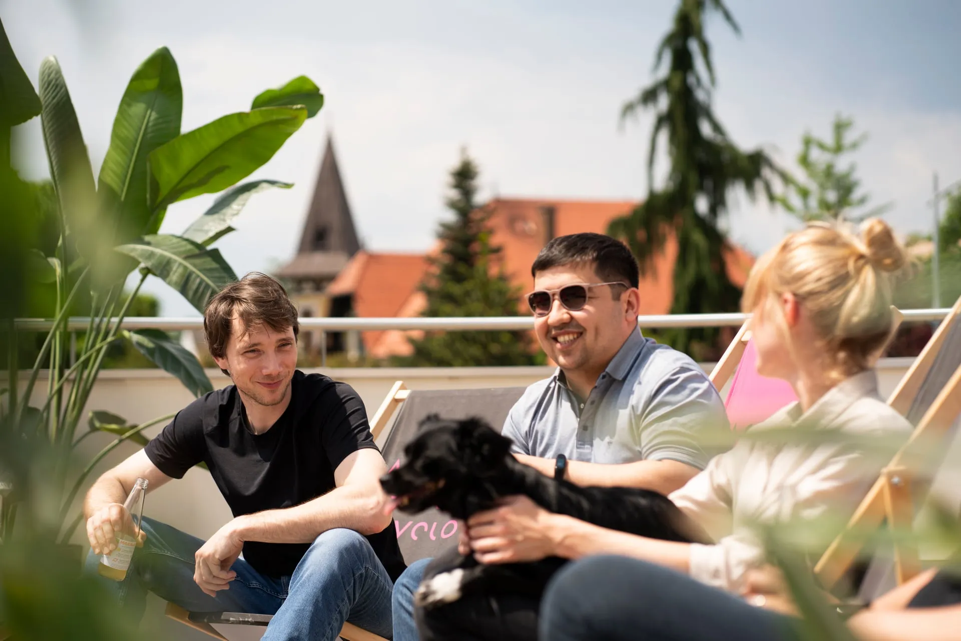 Guid.New team with the office dog on a break on the roof terrace